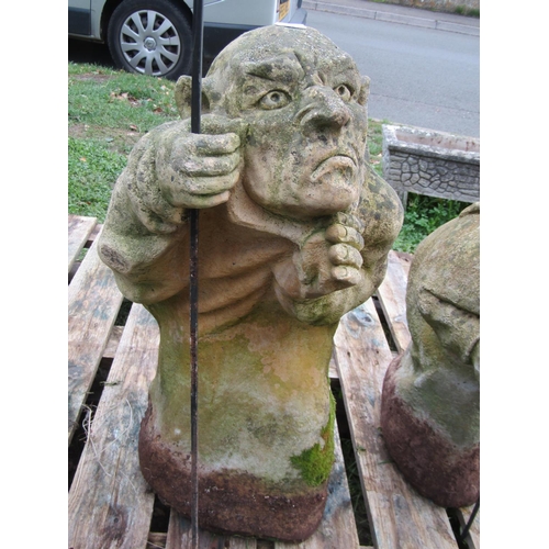 1061 - Three weathered cast composition stone garden ornaments in the form of goblins in varying poses but ... 