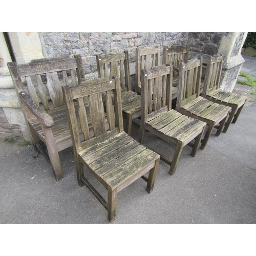 1062 - A set of eight (6&2) weathered heavy gauge teak garden chairs with slatted seats, backs and carved r... 