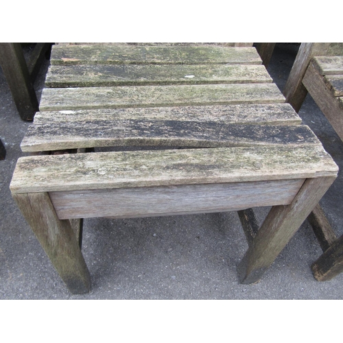 1062 - A set of eight (6&2) weathered heavy gauge teak garden chairs with slatted seats, backs and carved r... 