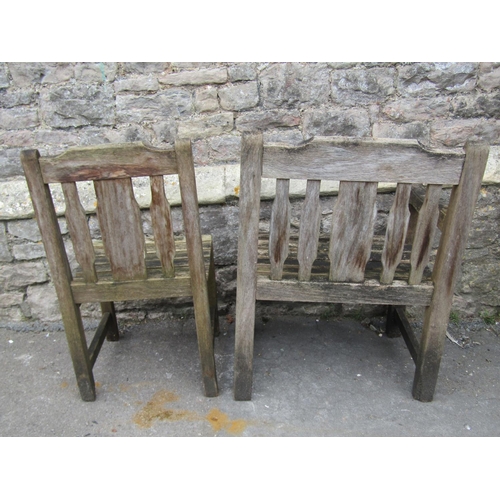 1062 - A set of eight (6&2) weathered heavy gauge teak garden chairs with slatted seats, backs and carved r... 