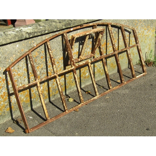 1093 - A reclaimed Georgian cast iron segmented window frame of rectangular and arched form with central op... 