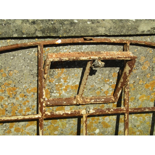 1093 - A reclaimed Georgian cast iron segmented window frame of rectangular and arched form with central op... 