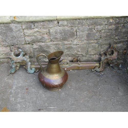 1096 - A 19th century Rococo fire curb/fender 127 cm together with a copper and brass jug with loop handle ... 