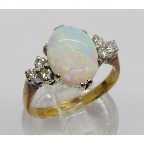 396 - Early to mid-20th century 18ct opal and diamond ring, the claw set oval opal flanked by a pair of di... 