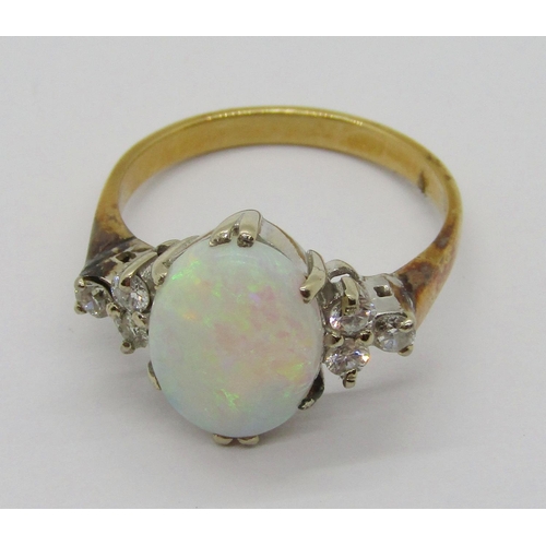 396 - Early to mid-20th century 18ct opal and diamond ring, the claw set oval opal flanked by a pair of di... 