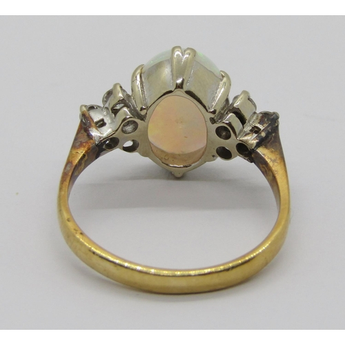 396 - Early to mid-20th century 18ct opal and diamond ring, the claw set oval opal flanked by a pair of di... 