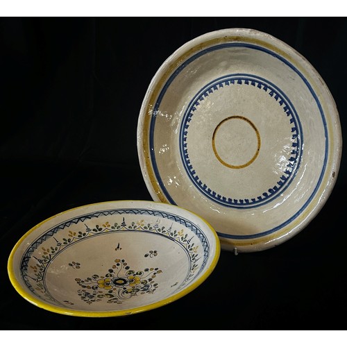 131 - Two Spanish pottery dishes with hand-painted floral and ring-banded detail, 35cm diameter maximum