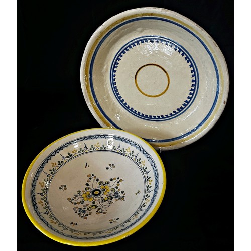 131 - Two Spanish pottery dishes with hand-painted floral and ring-banded detail, 35cm diameter maximum