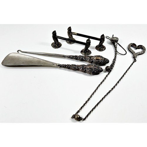 295 - A cased silver shoe horn and glove pull, together with a silver plated skirt lift and a pair of silv... 