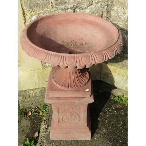 1024 - A pair of cast composition stone garden urns with faux terracotta finish, the squat circular lobed b... 