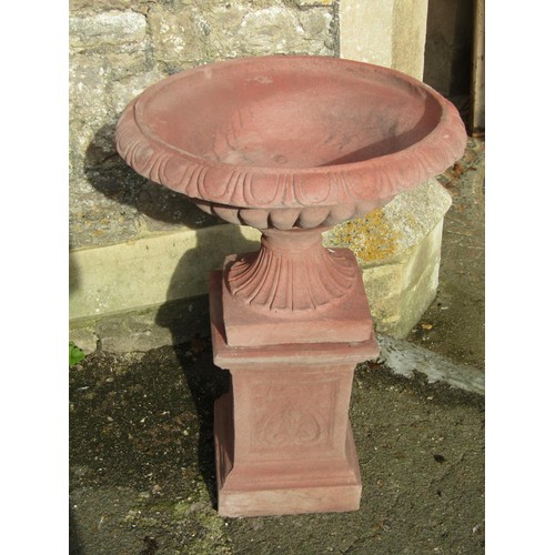 1024 - A pair of cast composition stone garden urns with faux terracotta finish, the squat circular lobed b... 