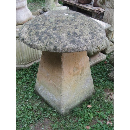 1055 - A composition stone staddle stone and domed cap, 65 cm high x 56 cm diameter