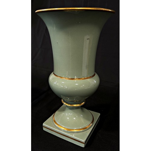 104 - A pair of celadon glazed campana shaped vases with gilded bands, 28cm high