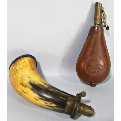 628 - An 18th century cow horn powder horn with a brass sprung dispenser and leather capped base, 19cm hig... 