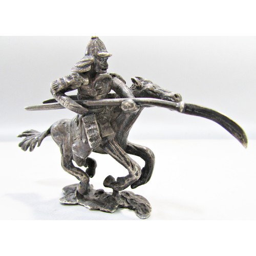 629 - Three white metal Dutch made Japanese military figures, one on horse back, one advancing, the squatt... 