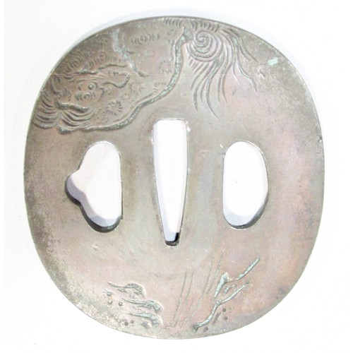 630 - A 19th century Japanese Tsuba for a sword, engraved with a mystical creature to one side a hill top ... 