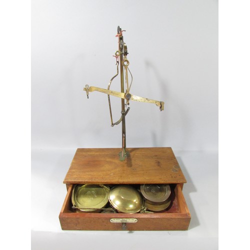 623 - A 19th century set of brass scales on a mahogany stand with a single drawer, made by Ge Grave, Short... 