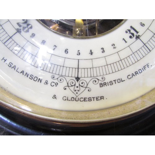 624 - A large carved oak Edwardian wheel barometer made by H.Salanson & Co, 32cm diameter and two smaller ... 