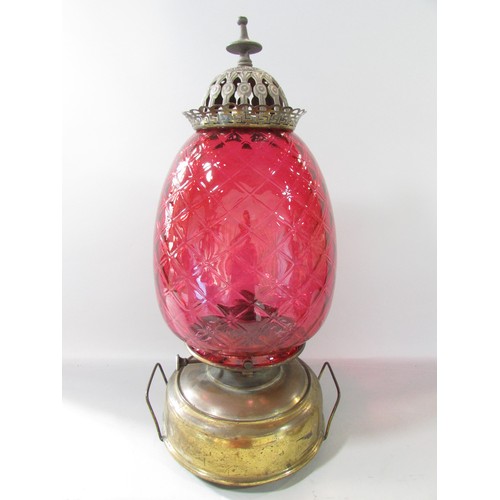 641 - A Victorian Globe Stove with a Union Burner, a cranberry glass diamond cut shade with a polished bra... 