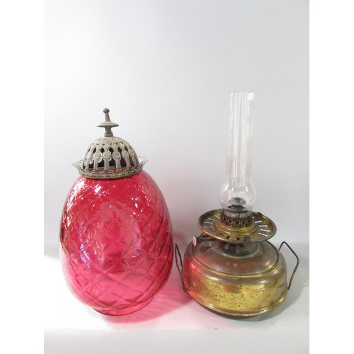 641 - A Victorian Globe Stove with a Union Burner, a cranberry glass diamond cut shade with a polished bra... 