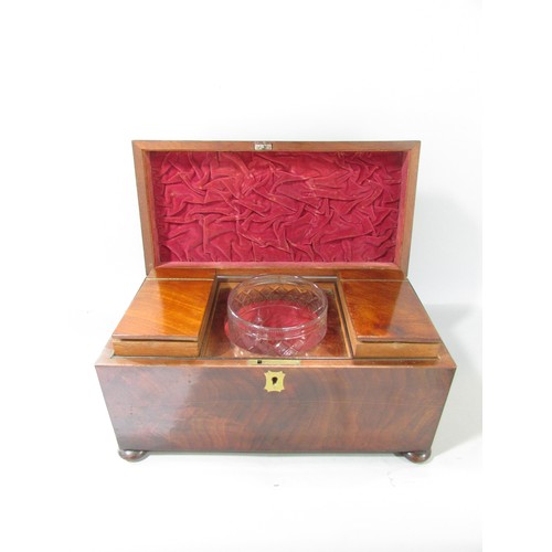 645 - A Georgian mahogany tea caddy open to reveal two wooden caddies and a glass mixing bowl, ring handle... 