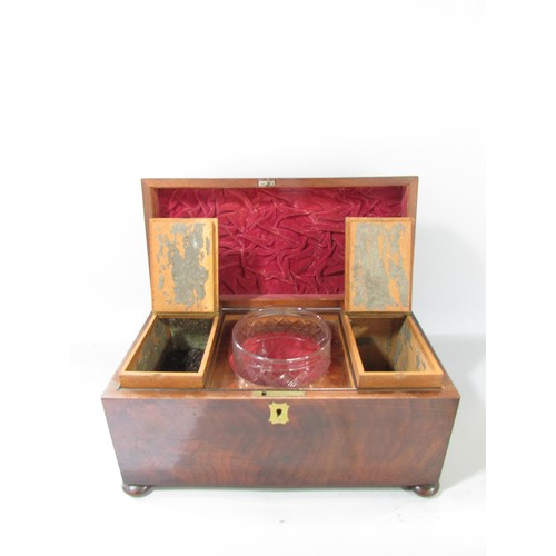 645 - A Georgian mahogany tea caddy open to reveal two wooden caddies and a glass mixing bowl, ring handle... 