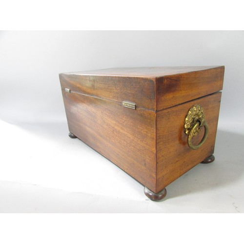 645 - A Georgian mahogany tea caddy open to reveal two wooden caddies and a glass mixing bowl, ring handle... 