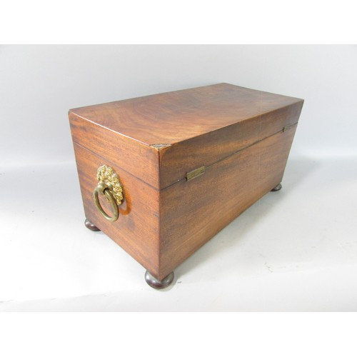 645 - A Georgian mahogany tea caddy open to reveal two wooden caddies and a glass mixing bowl, ring handle... 