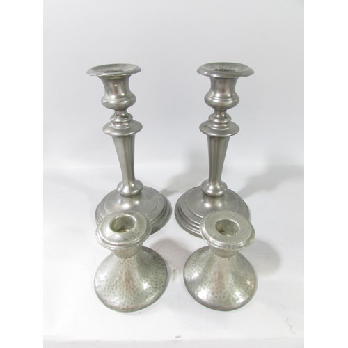 650 - A pair of 19th century pewter candlesticks 21cm high and a squat pair of lightly hammered candlestic... 