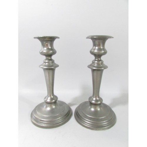 650 - A pair of 19th century pewter candlesticks 21cm high and a squat pair of lightly hammered candlestic... 