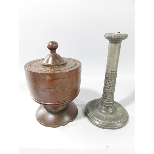 656 - A 19th century Lignum tobacco pot and cover and a pewter candlestick.