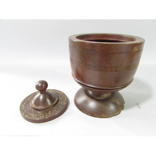 656 - A 19th century Lignum tobacco pot and cover and a pewter candlestick.