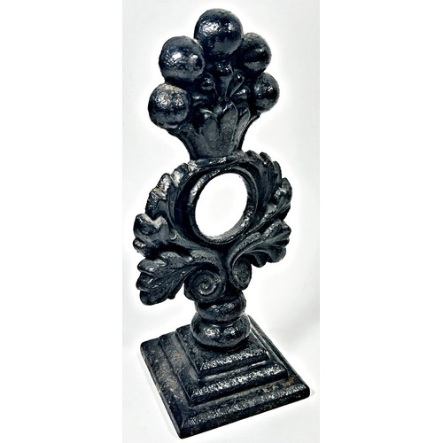 675 - A 19th century cast iron floral garland doorstop on a square stepped base, 27cm high.