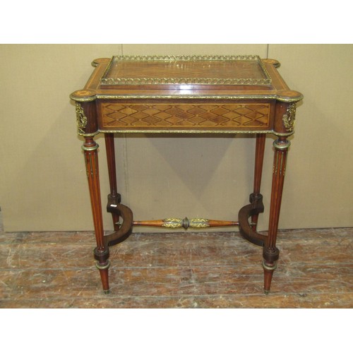 1611 - A 19th century French occasional table with geometric marquetry finish on reeded supports united by ... 