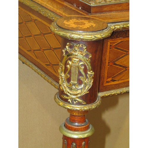 1611 - A 19th century French occasional table with geometric marquetry finish on reeded supports united by ... 