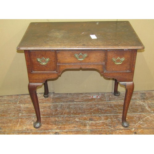 1612 - A Georgian oak countrymade lowboy of three drawers, raised on four pad feet, 71cm high x 79cm wide x... 