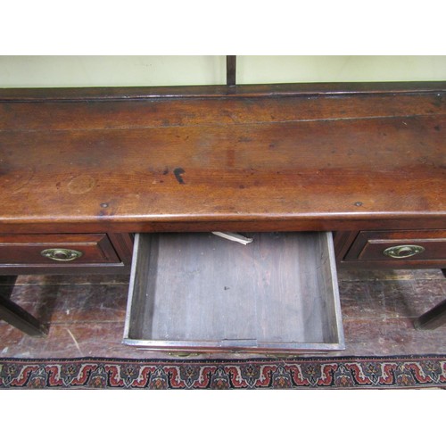 1616 - A George III country dresser with delft rack, the base fitted with three frieze drawers, 195cm high ... 