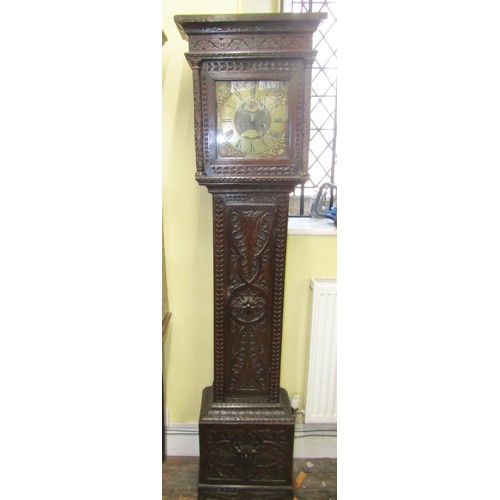 1617 - An 18th century longcase clock, the oak casework with later carved detail, enclosing a square brass ... 