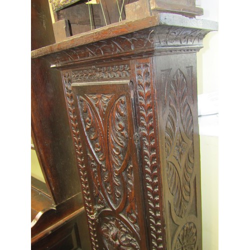 1617 - An 18th century longcase clock, the oak casework with later carved detail, enclosing a square brass ... 