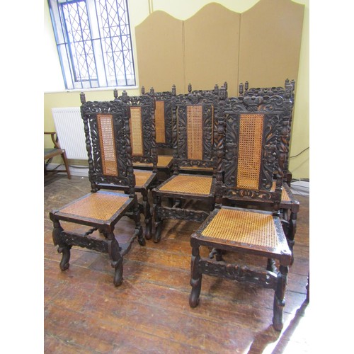 1620 - Set of eight Carolean style dining chairs in oak, with traditional carving and caned panel seats and... 