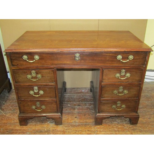 1622 - A Georgian mahogany kneehole desk enclosing eight drawers, the top drawer with fitted interior, with... 