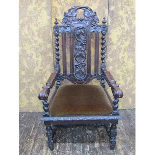 1628 - A Victorian carved oak elbow chair in the Charles II style with profusely carved detail