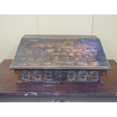 1636 - An 18th century oak writing slope with painted detail, the rising lid revealing a fitted interior, t... 