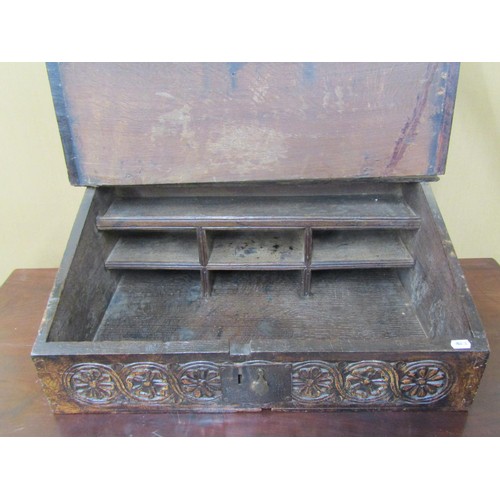 1636 - An 18th century oak writing slope with painted detail, the rising lid revealing a fitted interior, t... 