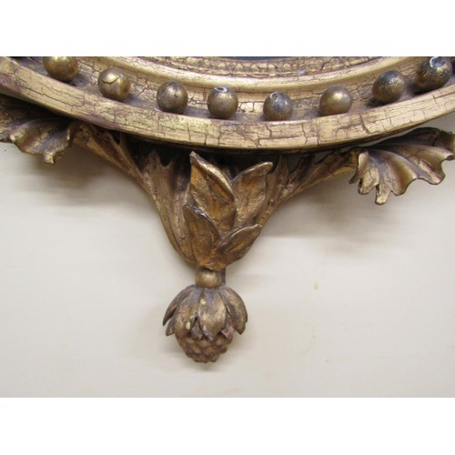 1638 - A regency convex mirror surrmounted by an eagle, supporting two candle sconces with original gilding... 