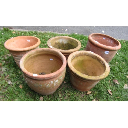 1070 - Five weathered terracotta planters of circular tapering form (slight variation in size and designs) ... 