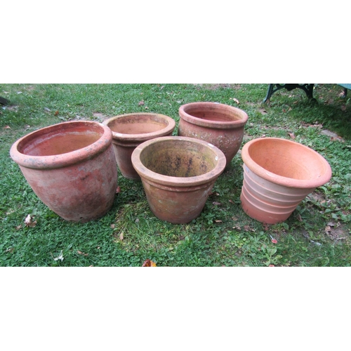 1070 - Five weathered terracotta planters of circular tapering form (slight variation in size and designs) ... 