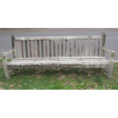 1074 - A substantial weathered teak garden/park bench with slatted seat and back, 248cm (8ft long) x 98cm h... 