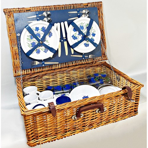 662 - A vintage wicker picnic hamper containing a Cole & Mason Melamine and plastic picnic set of cups and... 