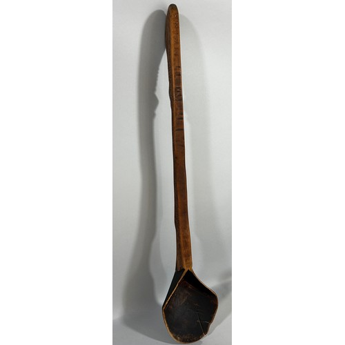 671 - An old hand made wooden spoon, possibly Zulu, from one piece of wood, 69cm long.